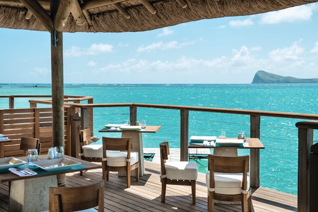 Paradise Cove restaurant, tables and chairs, on covered decking overlooking sea