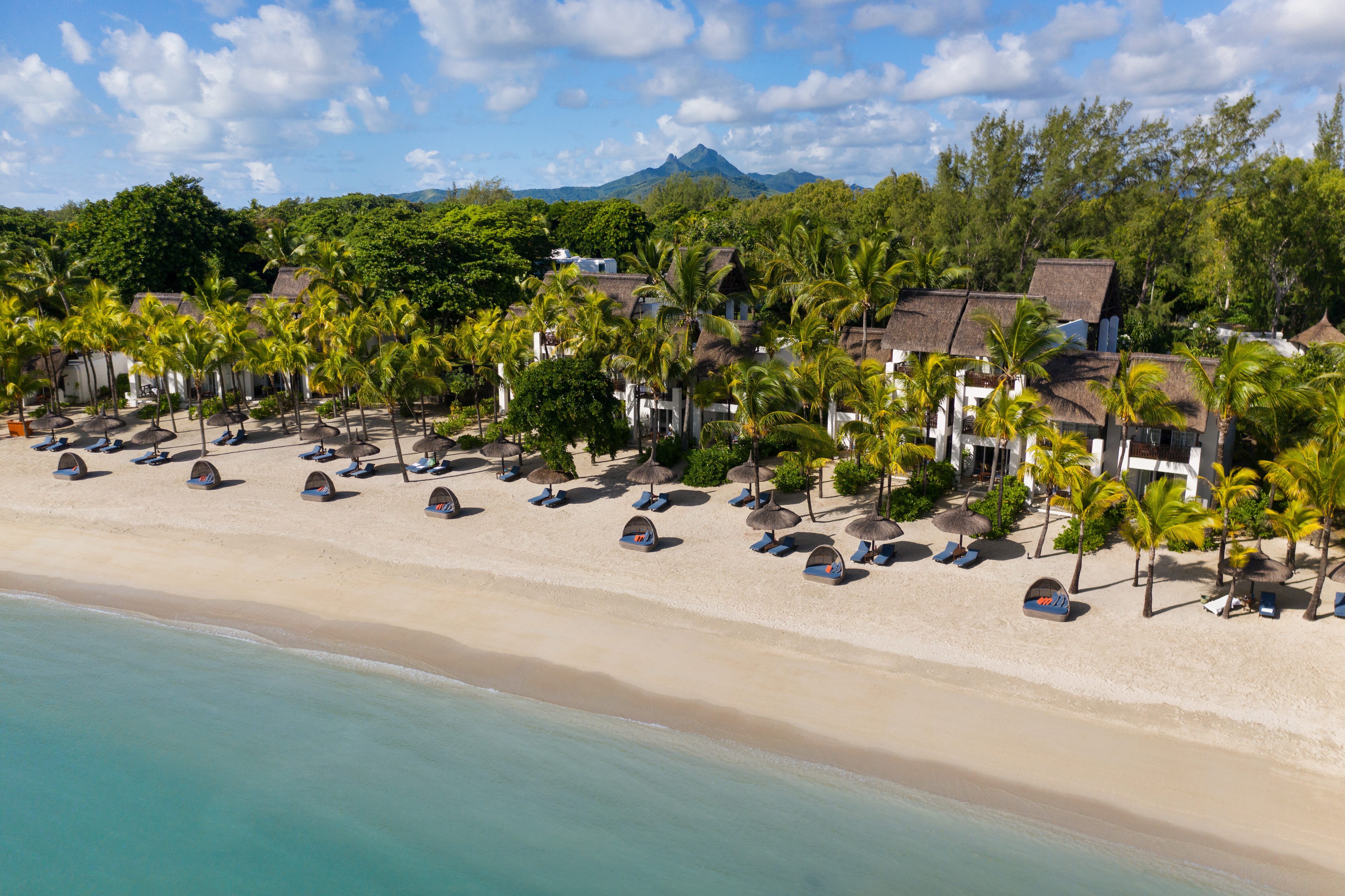 Aerial beach view with sun loungers and umbrellas set out 