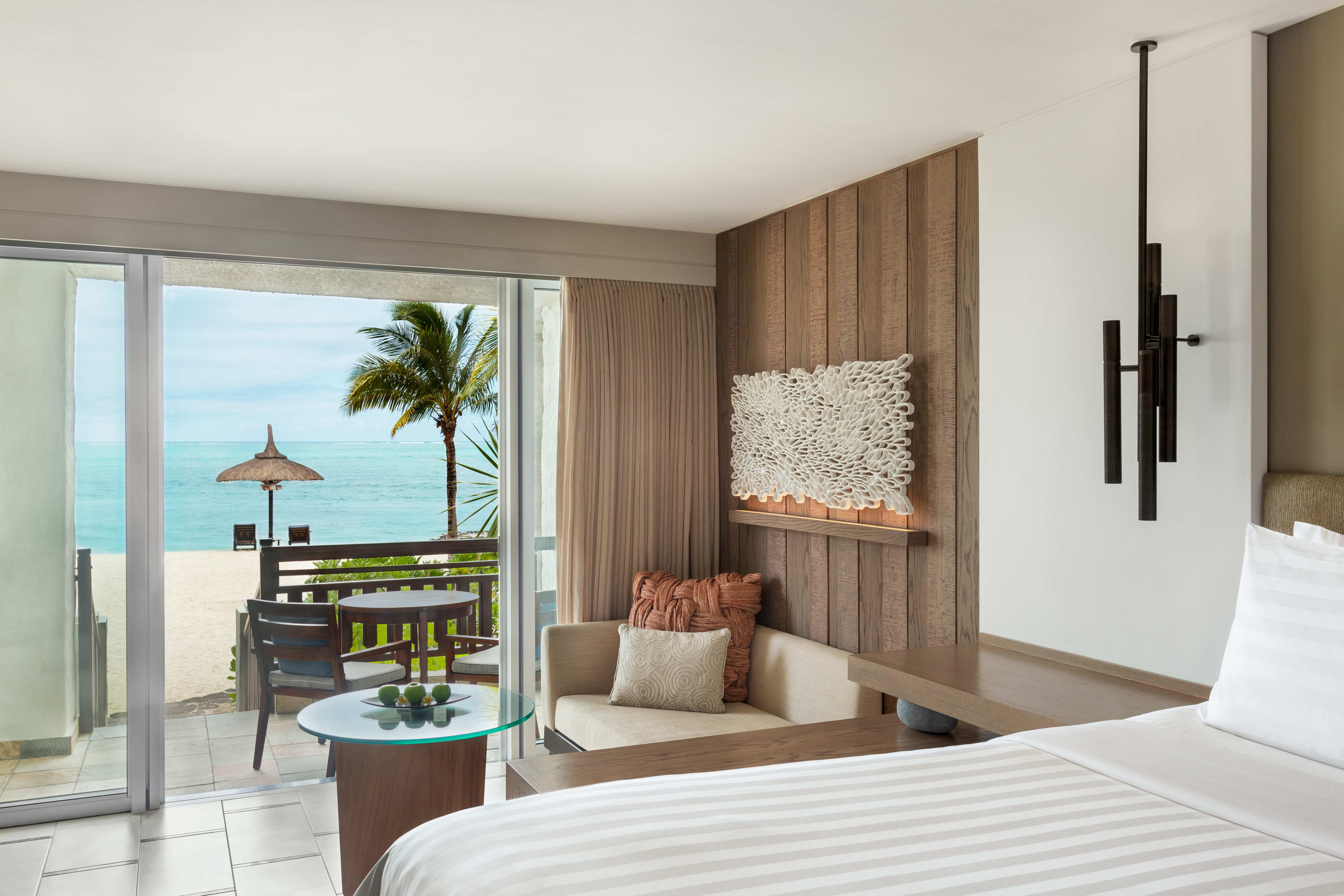 Deluxe coral room with large double bed and seating area 