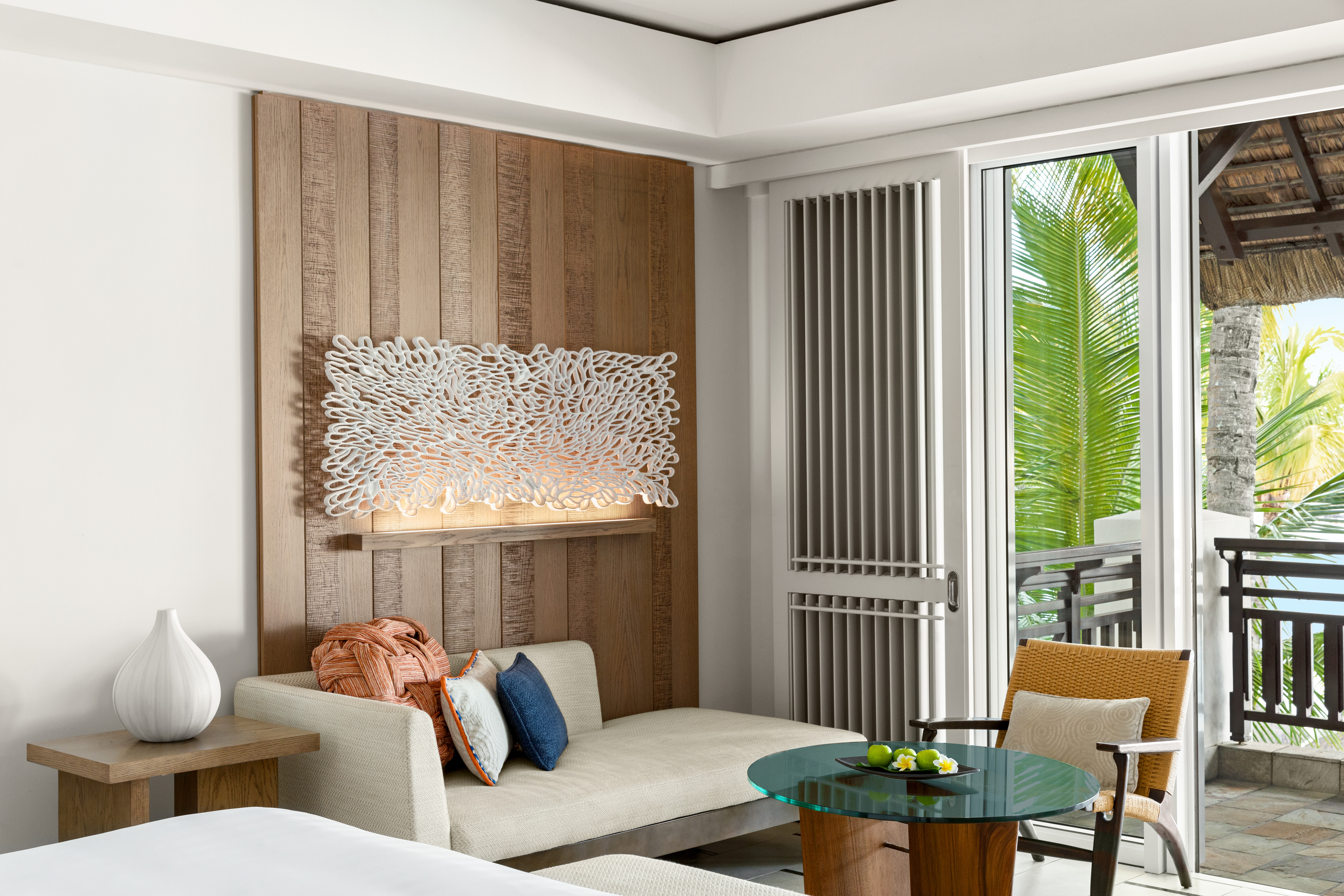 Junior suite with ocean view living area with sofa and balcony