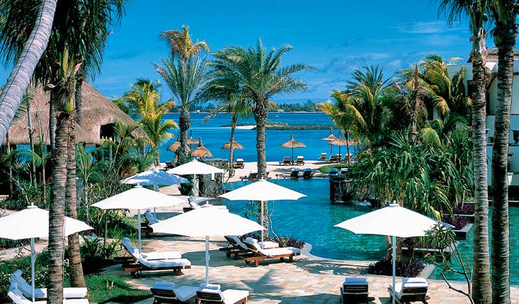 Shangri La Le Touessrok Mauritius outdoor pool loungers umbrellas palms ocean view