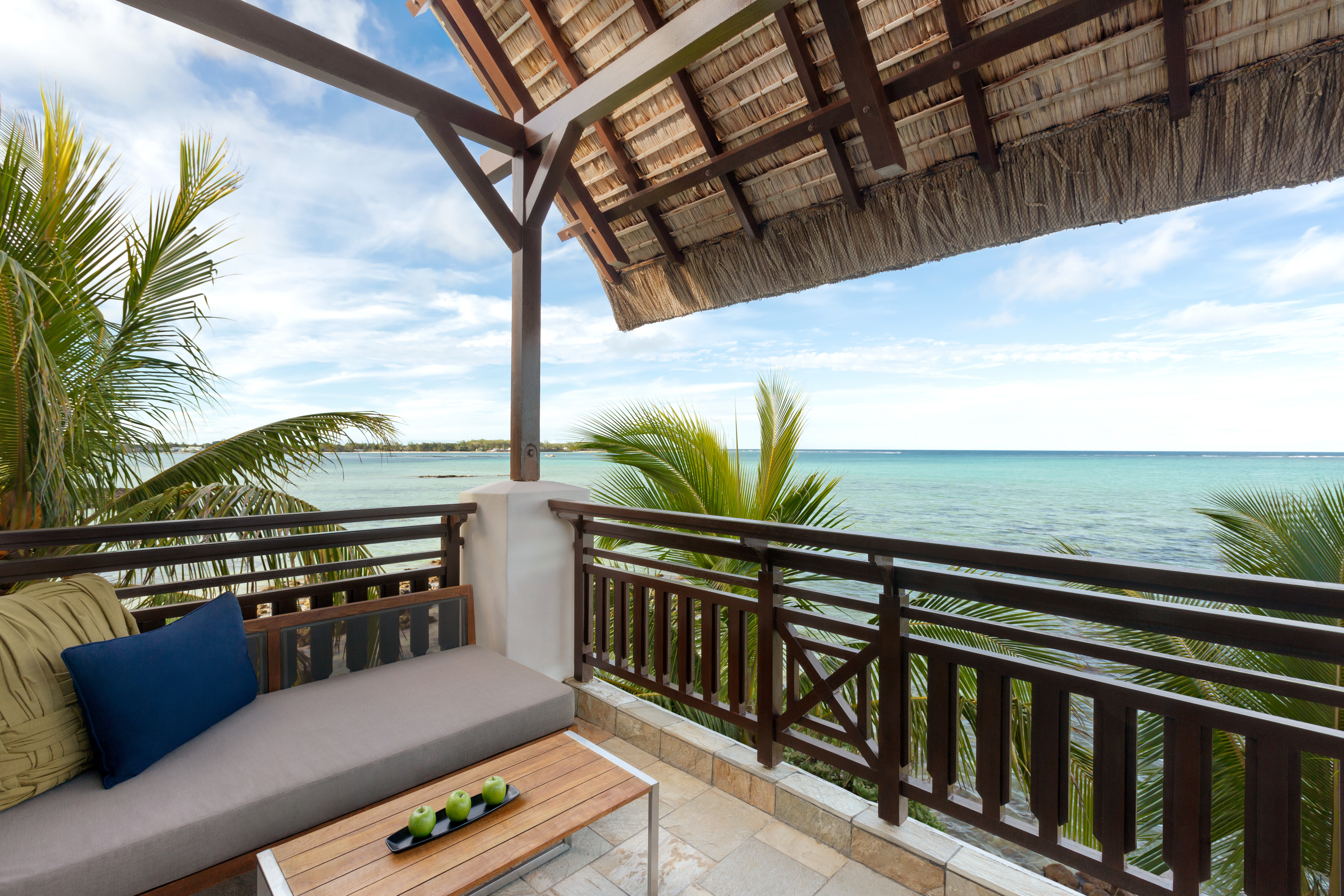 Suite terrace area with sofa and view over ocean 