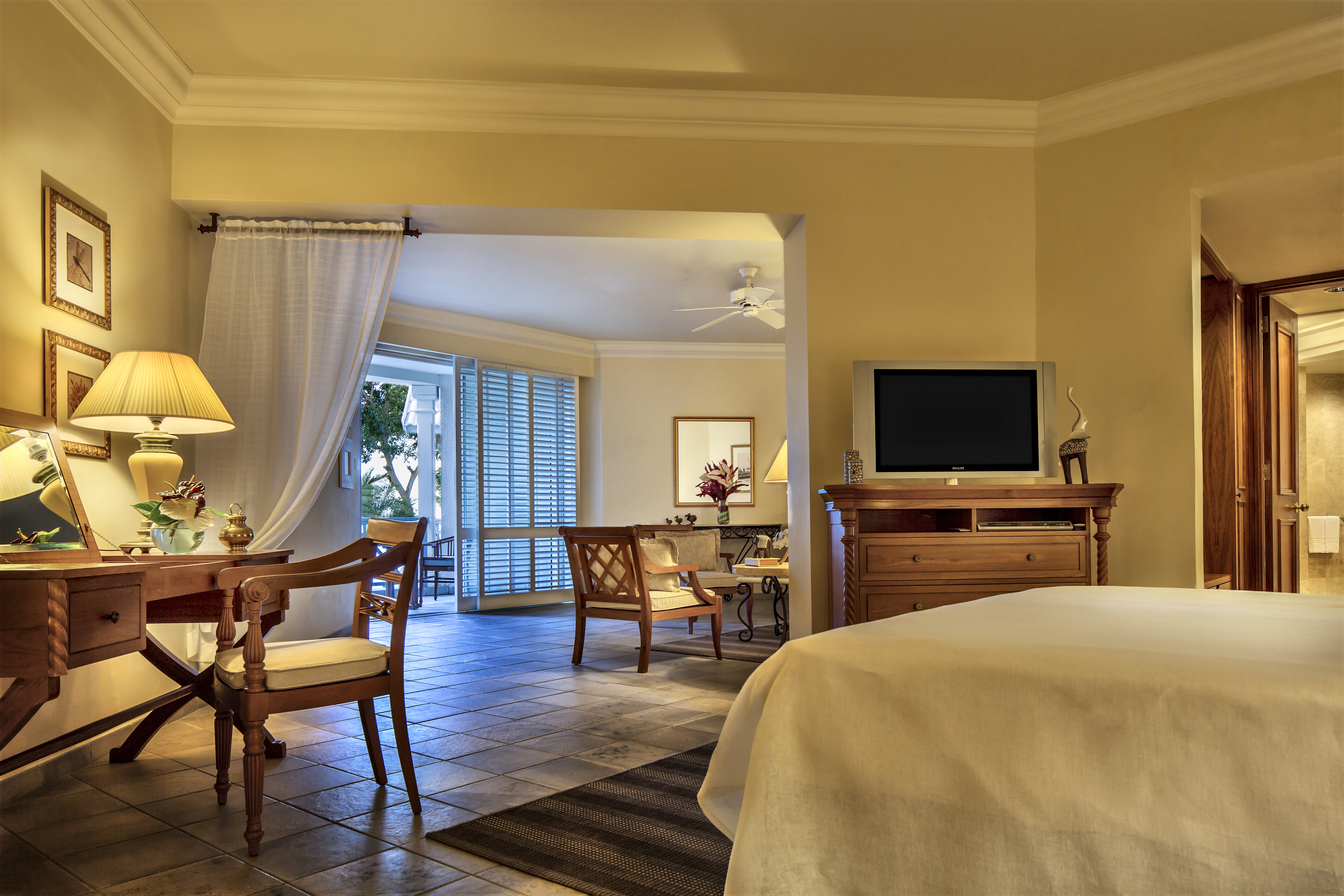 Garden view junior suite with double bed, television and lounge area