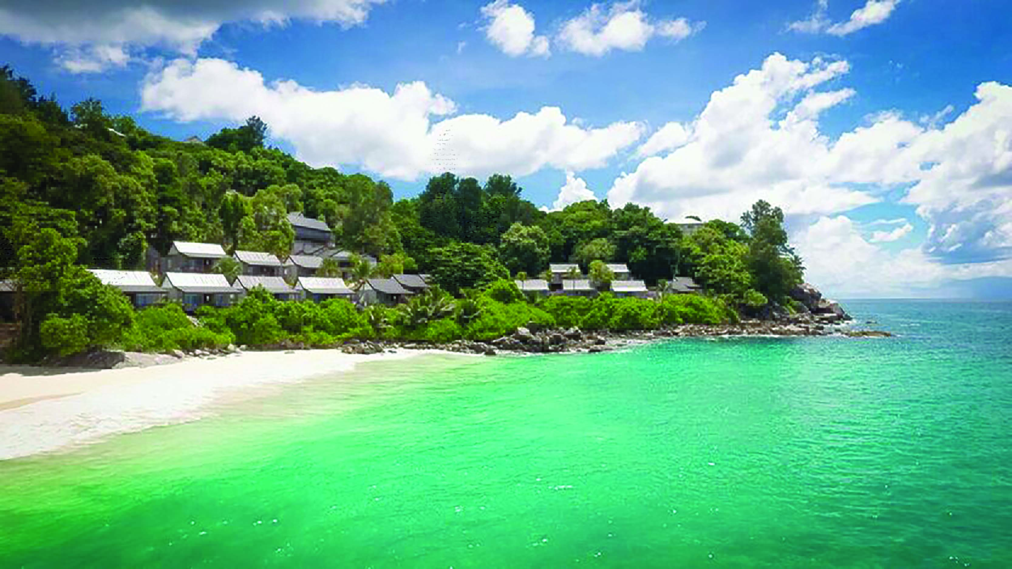 Carana Beach Hotel beach, clear turquoise sea, white sand, villas nestled in tropical greenery