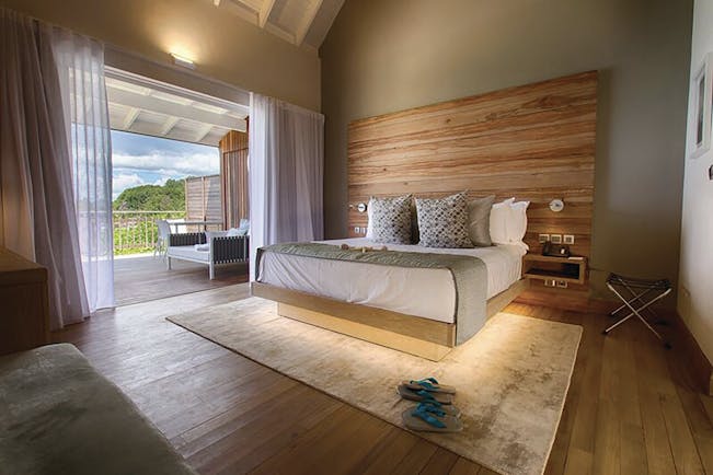 Carana Beach Hotel ocean view chaler interior, double bed, access to terrace, fresh modern decor