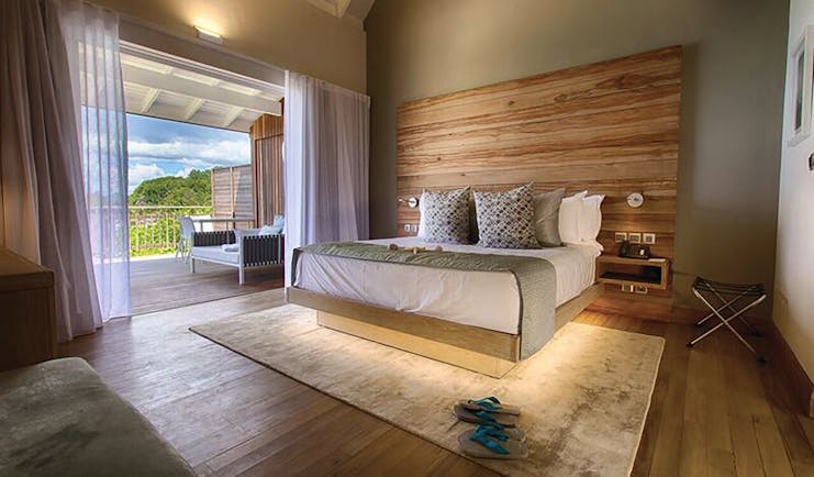 Carana Beach Hotel ocean view chaler interior, double bed, access to terrace, fresh modern decor