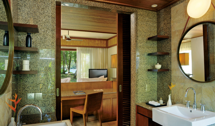 Constance Ephelia Resort Seychelles bathroom view of villa lounge and garden