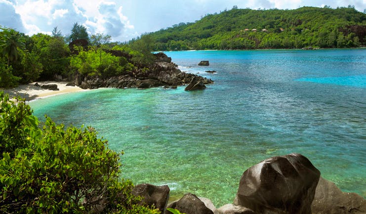 Constance Ephelia Resort Seychelles beach view clear green water greenery