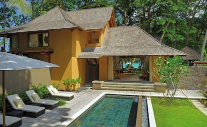 Constance Ephelia Resort Seychelles beach villa yellow building sun loungers private pool