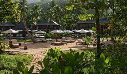 Constance Ephelia Resort Seychelles garden beach sun loungers umbrellas lanterns