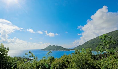 Constance Ephelia Resort Seychelles island view ocean forest covered island 