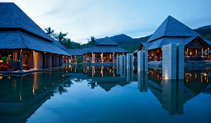 Constance Ephelia Resort Seychelles main outdoor pool buildings mountains 