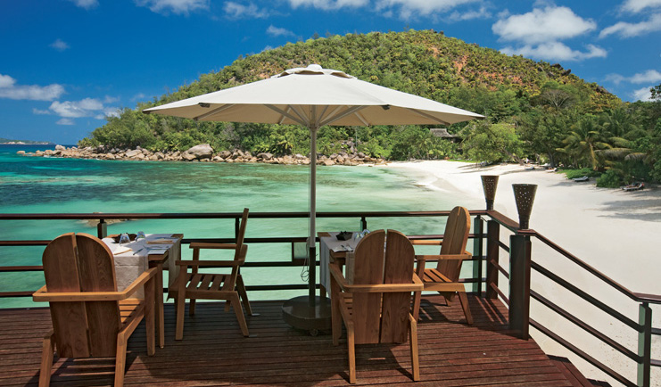 Constance Lemuria Seychelles beachfront restaurant decked dining area umbrella