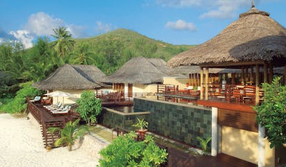 Constance Lemuria Seychelles bungalows thatched rooves deck loungers beach view