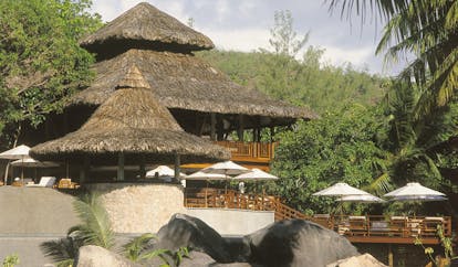 Constance Lemuria Seychelles hotel buildings thatched rooves forest view