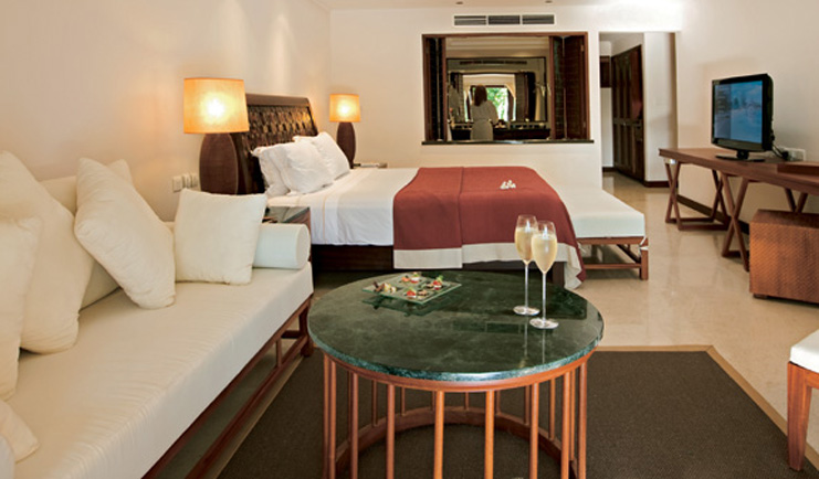 Constance Lemuria Seychelles junior suite bedroom sitting area champagne