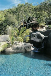 Constance Lemuria Seychelles outdoor pool rocks greenery