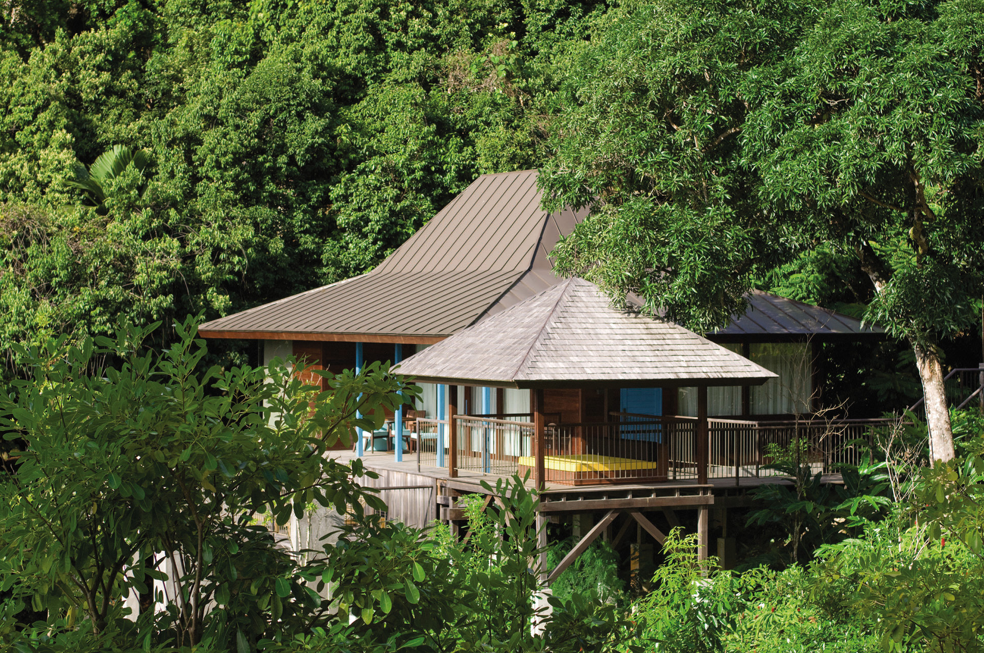 Exterior of part of the hotel building shown amidst greenery 