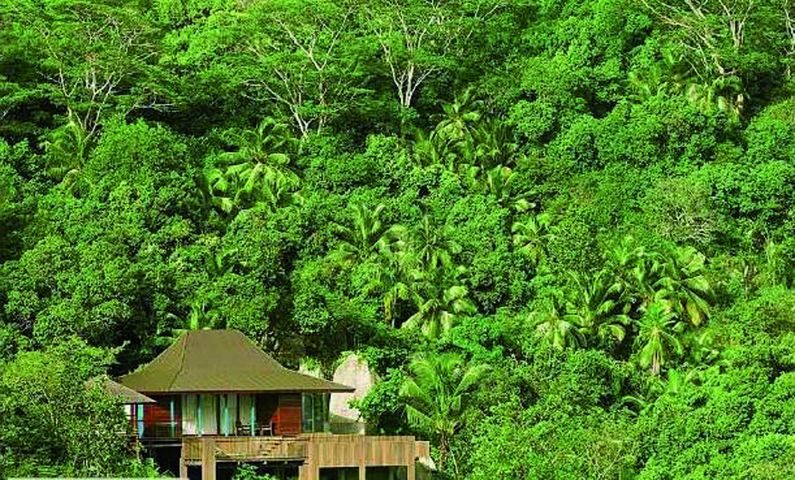 Four Seasons Resort villa exterior, building nestled amongst tropical greenery