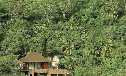 Four Seasons Resort villa exterior, building nestled amongst tropical greenery