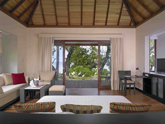 Hilton Labriz Seychelles beach villa bedroom seating area trees ocean view