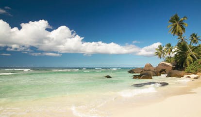 Hilton Labriz Seychelles beach white sand palm trees 