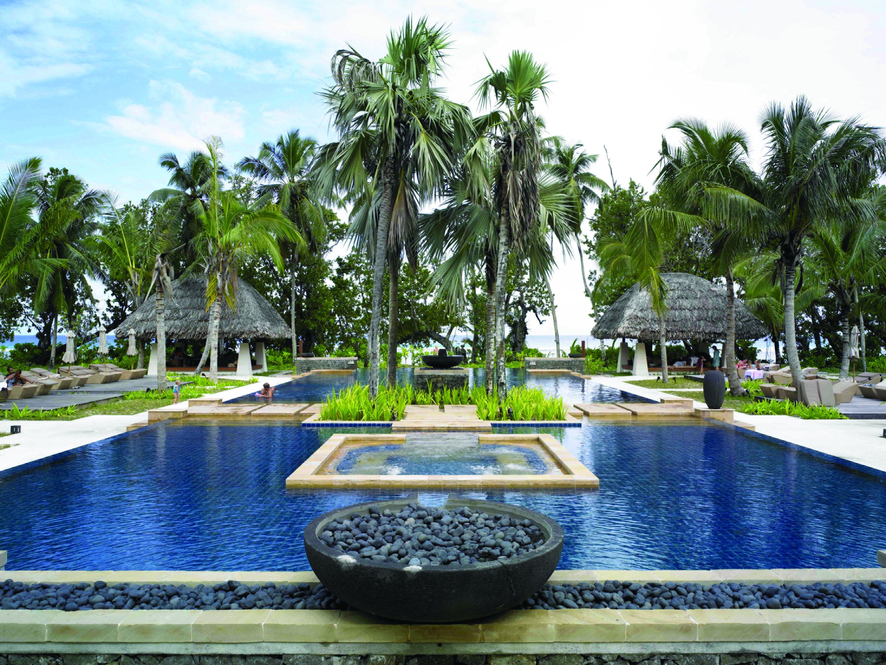 Hilton Labriz Seychelles outdoor pool palm trees ocean view