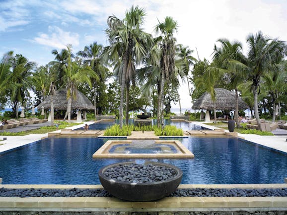 Hilton Labriz Seychelles outdoor pool palm trees ocean view