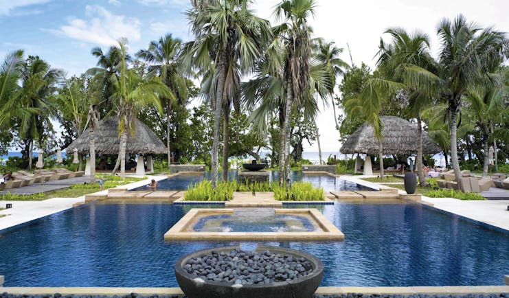 Hilton Labriz Seychelles outdoor pool palm trees ocean view