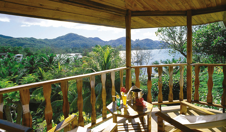Hotel L'Archipel Seychelles covered balcony seating forest and ocean view