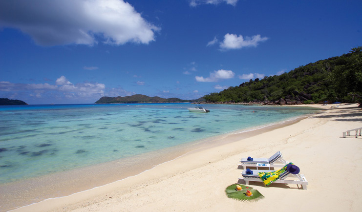 Domaine de la Reserve Seychelles aerial beach sun loungers white beach boat on waves