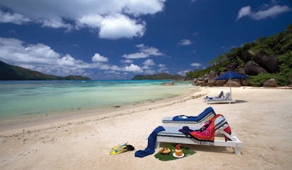 Domaine de la Reserve Seychelles beach sun loungers grassy hills