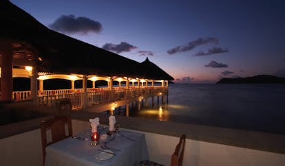 Domaine de la Reserve Seychelles evening outdoor dining jetty 