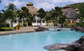 Domaine de la Reserve Seychelles exterior pool white building palm trees
