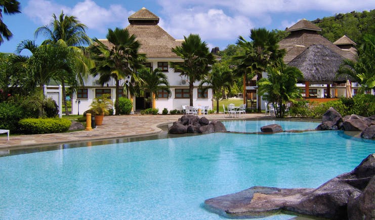 Domaine de la Reserve Seychelles exterior pool white building palm trees