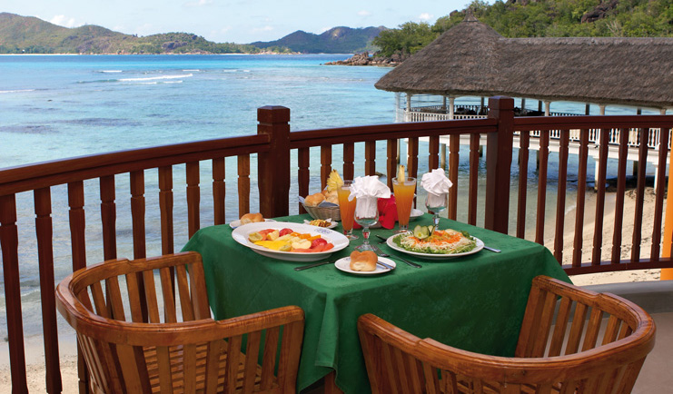 Domaine de la Reserve Seychelles outdoor dining terrace ocean and jetty view