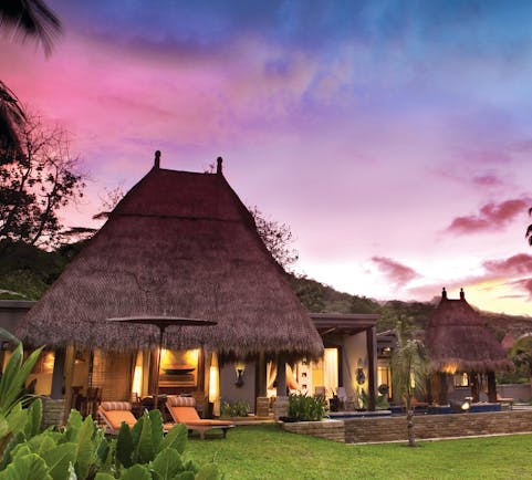 Maia Seychelles villa exterior sun loungers lawn gardens terrace