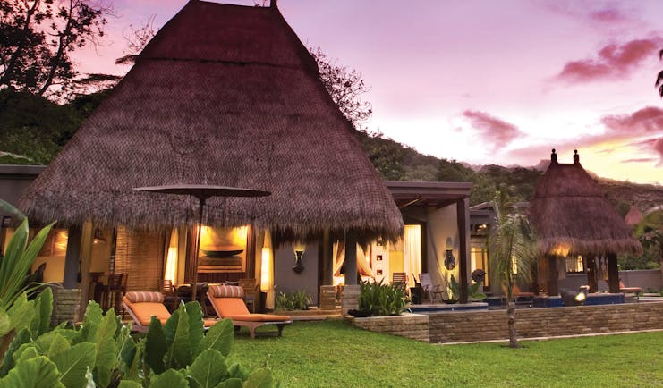 Maia Seychelles villa exterior sun loungers lawn gardens terrace