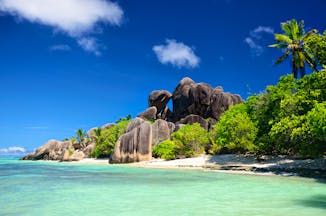 Rock formation and white sandy beach with turquoise blue sea in the Seychelles