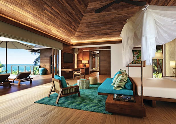 Six Senses Zil Pasyon villa interior, bed, sofa, private terrace with sun loungers