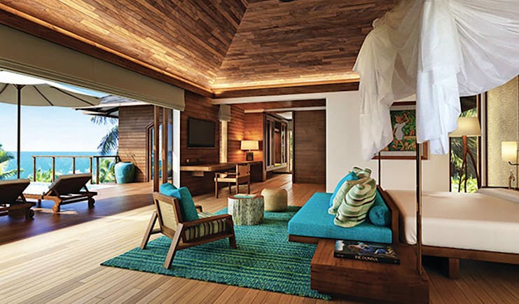 Six Senses Zil Pasyon villa interior, bed, sofa, private terrace with sun loungers