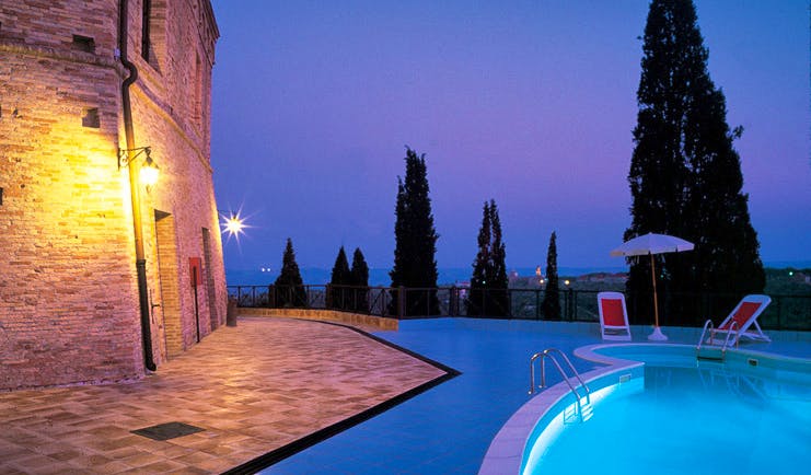 Castello Chiola Abruzzo pool at night terrace sun loungers 