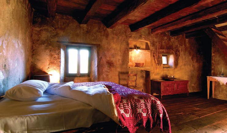 Sextantio Albergo Diffuso Abruzzo classic room bed roof beams authentic architecture