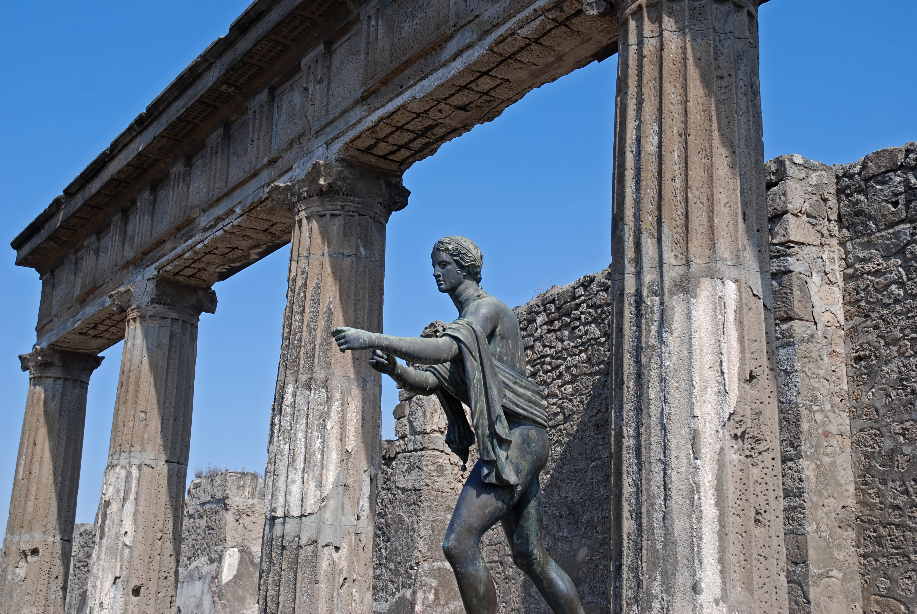 Statue of Apollo stretching out arm at Roman temple in Pompeii