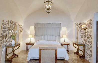 Hotel Caruso Amalfi Coast bedroom large bed stone detailing on walls