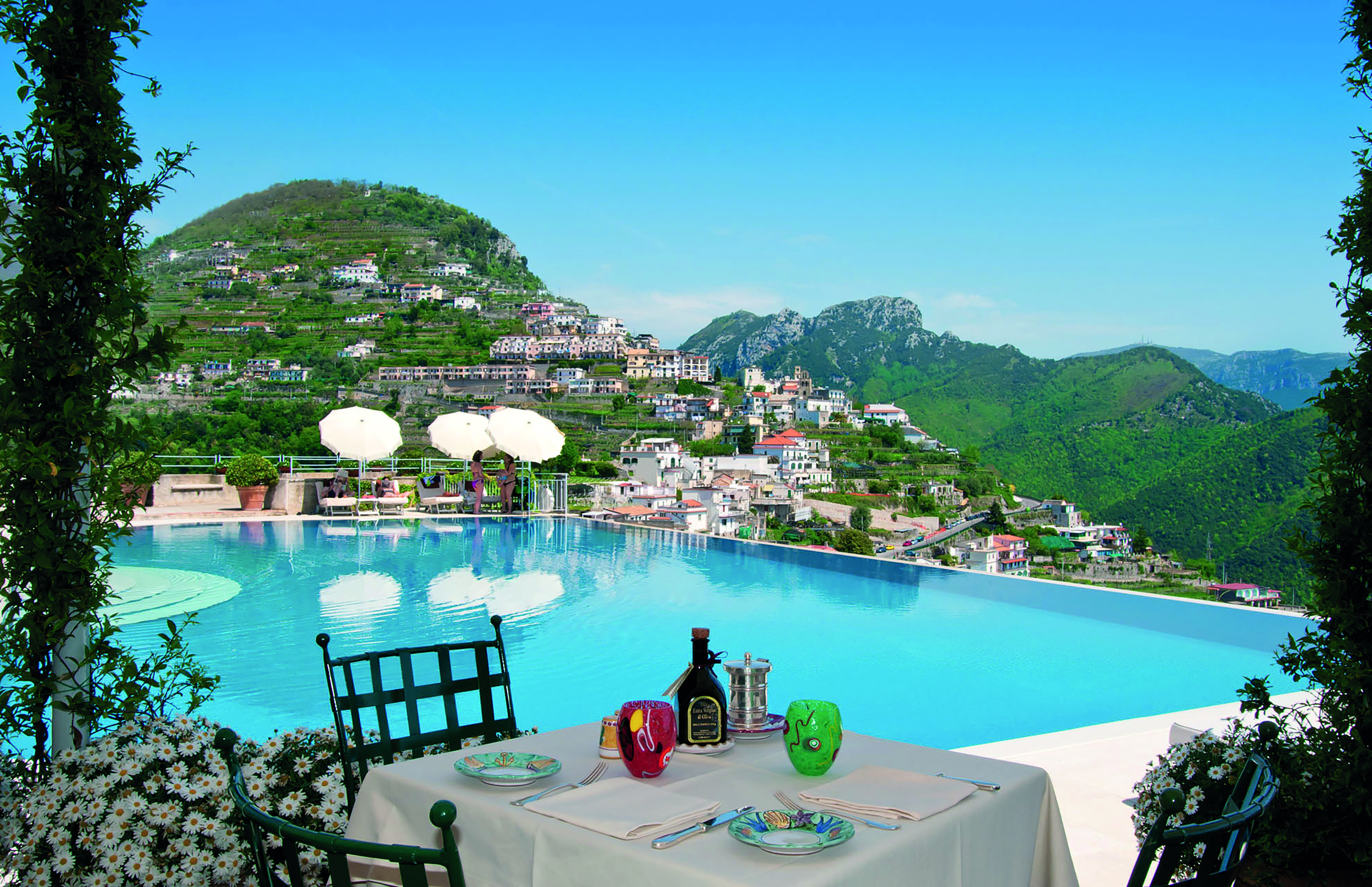 Hotel Caruso Amalfi Coast infinity pool outdoor dining view of mountains