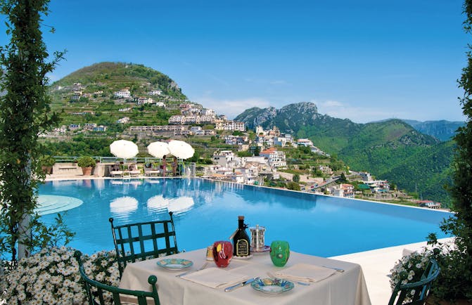 Hotel Caruso Amalfi Coast infinity pool outdoor dining view of mountains