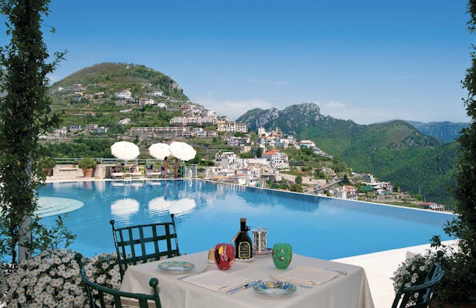 Hotel Caruso Amalfi Coast infinity pool outdoor dining view of mountains