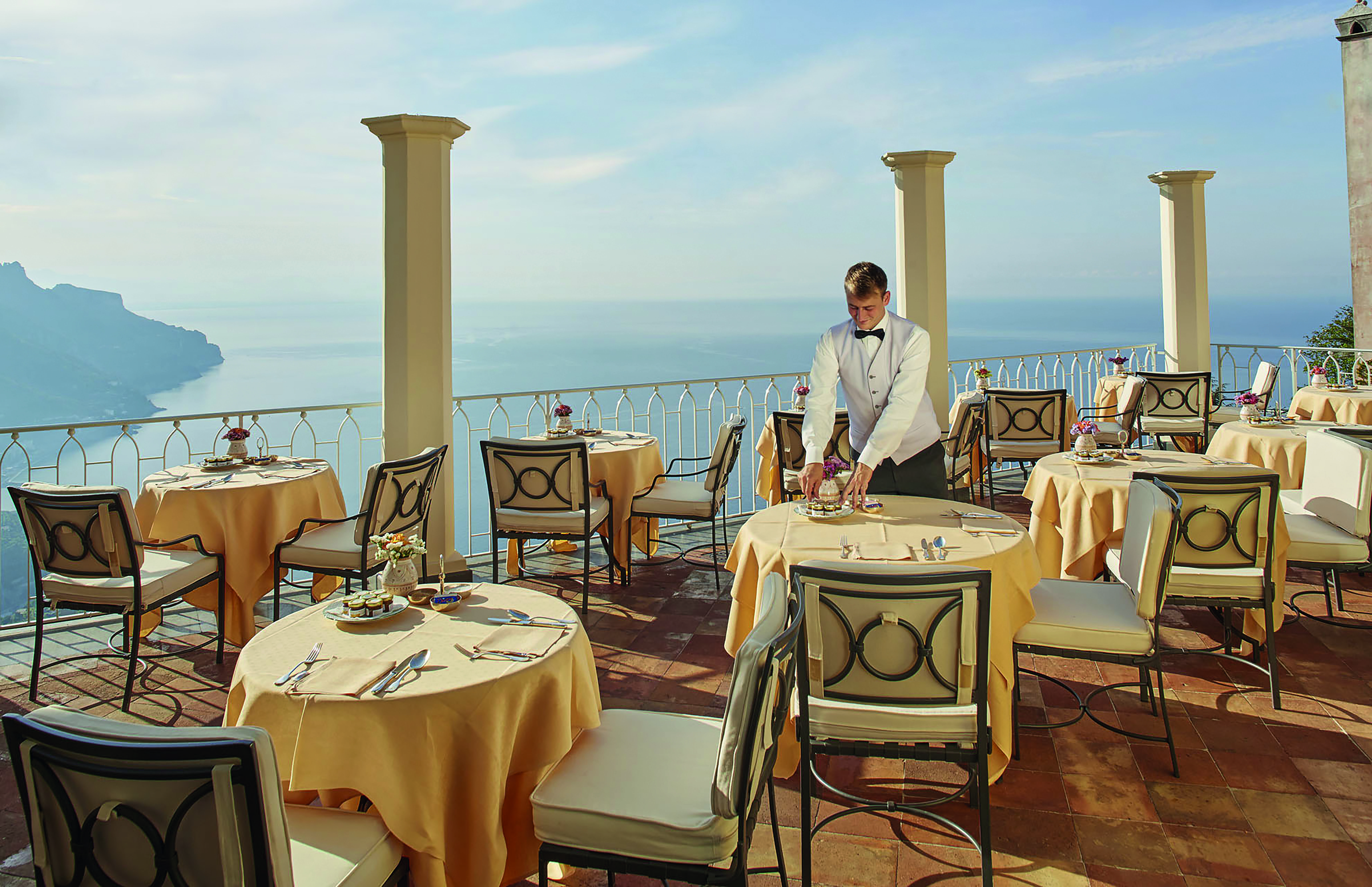 Hotel Caruso Amalfi Coast restaurant terrace waiter dining tables chairs overlooking the sea