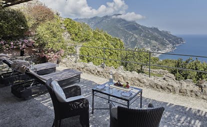 Hotel Caruso Amalfi Coast terrace in the cliffside outdoor seating area overlooking the coast line